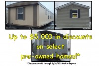 A photo of three single-wide manufactured homes with an advertisement for reduced prices.